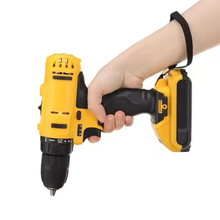 Holding a yellow cordless electric drill in hand